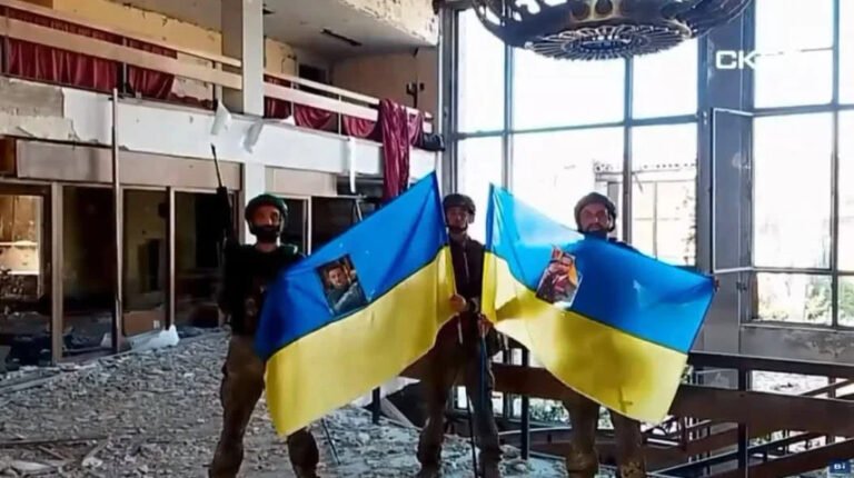 Скриншот відео: бійці "Скелі" з українськими прапорами та фото керівництва, потрапивши в полон у Костянтинівці.